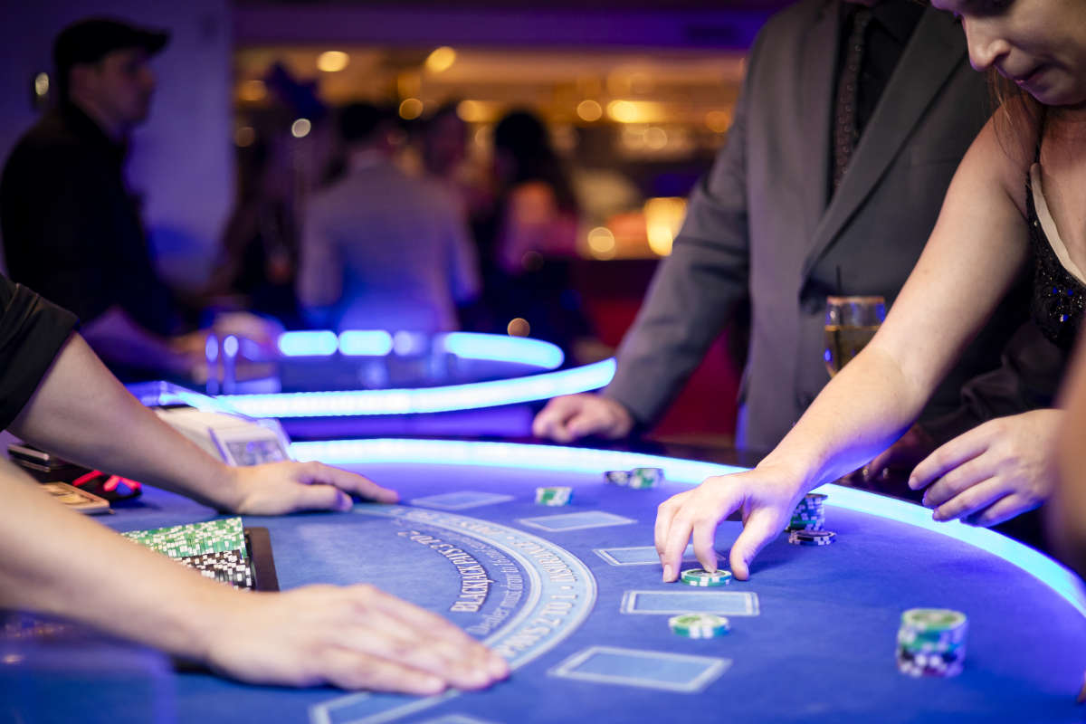 dealer dealing cards to patrons at a table rental event