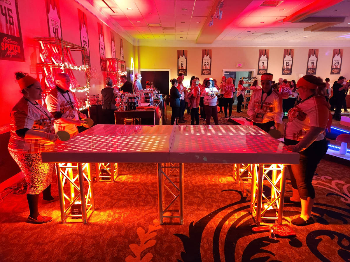 Teens playing LED ping pong at a bar mitzvah party